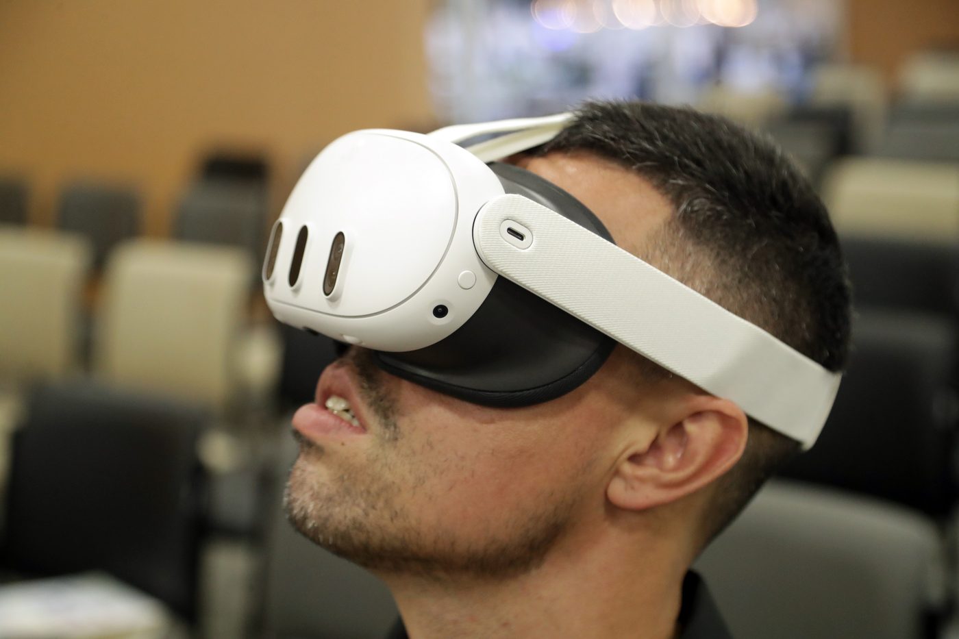 A person wearing a Meta Quest 3 virtual reality headset, side profile